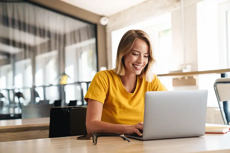 Woman smiling with on laptop